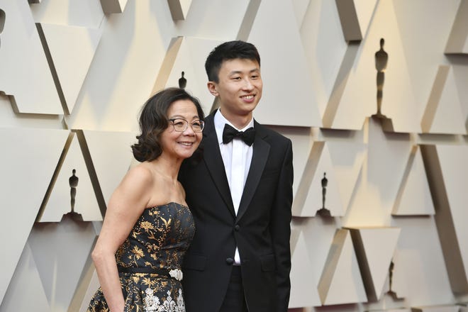 Diane Quon, left, and Bing Liu arrive at the Oscars. Liu will attend a screening and discussion of his Oscar-nominated documentary "Minding the Gap" on Friday at New College of Florida. (Photo by Jordan Strauss/Invision/AP)