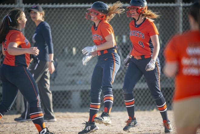 Rochester's Addison Cline (11) celebrates with her teammates after her single drove in the winning run in the bottom of the eighth inning of the Rockets' 1-0 win over Chatham Glenwood on Tuesday in Rochester. [JUSTIN L. FOWLER/THE STATE JOURNAL-REGISTER]