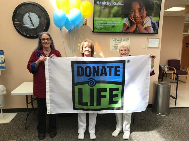 Fairchild Medical Center Auxiliary volunteers set up a Donate Life booth in the FMC lobby on Friday, April 12 to celebrate Blue and Green Day. The day promotes education about organ, eye and tissue donation and encourages people to sign up to become donors. From left are FMC Auxiliary members Nancy Sylva, M’Liss Jennings and Marian Hamilton.