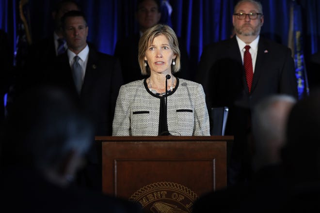 FBI Executive Assistant Director Amy Hess speaks beside members of Appalachian Regional Prescription Opioid Strike Force during a news conference Wednesday in Cincinnati. Federal authorities have charged 60 people, including 31 doctors, for their roles in illegal prescribing and distributing millions of pills with opioids and other dangerous drugs. [AP Photo/John Minchillo]