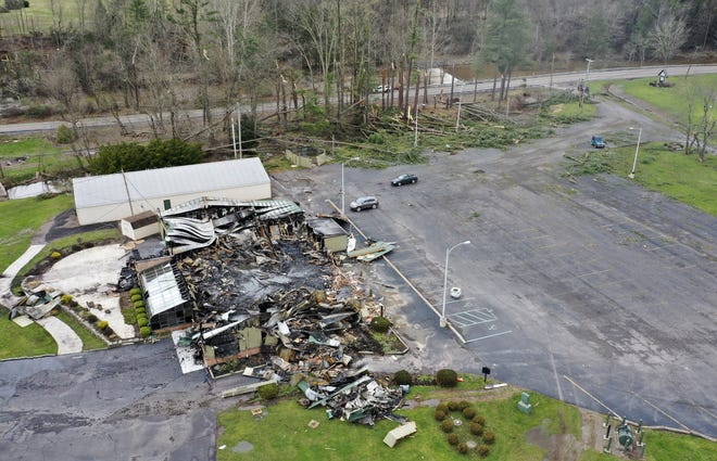 The remains of the Mill Race Golf Course clubhouse lie in the foreground, and trees are leveled in the background, Monday, April 15, 2019, in Benton, Pa., after being damaged by an EF1 tornado, according to the National Weather Service. [Jimmy May/Bloomsburg Press Enterprise via AP]