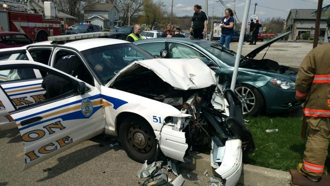 An Akron police officer escorting a funeral procession was injured Thursday when another vehicle crashed into the cruiser on Darrow Road. A driver and passenger in the other vehicle were treated for injuries as well. [Courtesy of Akron Police]
