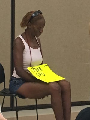 Newtown resident Katrina Clemons wears a sign, "I Fear SPD," to a recent neighborhood meeting that included Sarasota Police Chief Bernadette DiPino. [Herald-Tribune staff photo / Carrie Seidman]