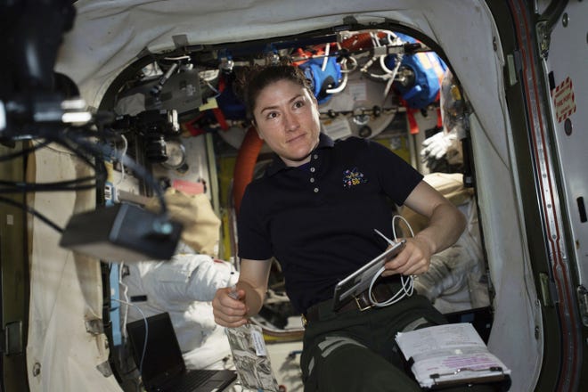 In this April 8, 2019, astronaut and Expedition 59 Flight Engineer Christina Koch works on U.S. spacesuits inside the Quest airlock of the International Space Station. Koch will remain on board until February 2020, approaching but not quite breaking Scott Kelly's 340-day U.S. record. (NASA via AP)