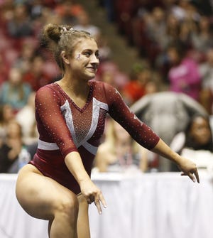 Abby Armbrecht has a smile on her face after completing her floor exercise during the senior night performance against Auburn. She will compete as an individual tonight in Forth Worth, Texas, at the NCAA Championships. [Staff Photo/Gary Cosby Jr.]