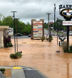 A flash flood closed this shopping center at Banks Crossing north of Commerce on Friday. [Hen's Nest Consignment Shop photo]
