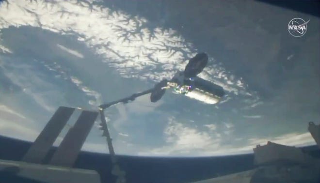This photo provided by NASA shows a cargo ship arriving at the International Space Station, Friday, April 19, 2019.  Space station astronaut Anne McClain used a robot arm to capture Northrop Grumman’s Cygnus capsule as they soared 258 miles (415 kilometers) above France. The Cygnus and its 7,600-pound (3,450-kilogram) shipment rocketed from Wallops Island, Va., on Wednesday, completing the trip in short order. (NASA via AP)