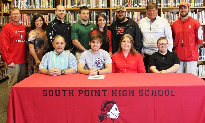 HEADED TO BLUEFIELD: South Point's Caleb Gibson has signed a national letter of intent to play football at Bluefield College. Pictured (left to right) on the front row are his father, Chip Gibson; Caleb Gibson; his mother, Sharon Gibson; and his brother Trey Gibson and back row South Point Athletic Director, Kent Hyde; South Point Assistant Principal, Stephanie Denton; South Point Offensive Coordinator, Josh Justice; Caleb's brother, Garrett Gibson; his sister, Leah Brooks; South Point Head Football coach, Adam Hodge; former South Point head football coach, Mickey Lineberger; and South Point Defensive Backs coach, James Justice. [Special to The Gazette]