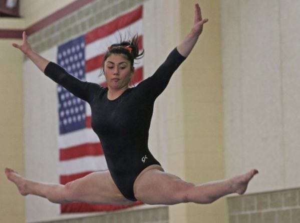 West Warwick's Alyssa Worthington competes on the beam during the Midge Palmer Individual Championship Meet in February. Worthington won her third individual state title.