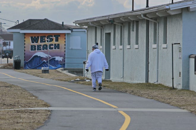 Joe Neves walks past the West Beach Boathouse in the South End of New Bedford during his morning walk. 

[ PETER PEREIRA/THE STANDARD-TIMES FILE ]