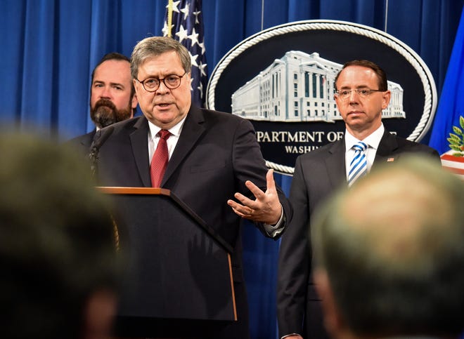 Attorney General William Barr, center, answers a question during a press conference hours before releasing a version of the Mueller report, on April 18, 2019 in Washington. Deputy Attorney General Rod Rosenstein is behind him at right. At left is Acting Principal Associate Deputy Attorney General Ed O'Callaghan. MUST CREDIT: Washington Post photo by Bill O'Leary