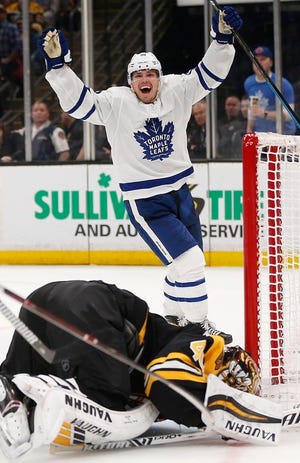 Toronto Maple Leafs' Andreas Johnsson (18) celebrates a goal by Kasperi Kapanen on Boston Bruins' Tuukka Rask, bottom, during the third period in Game 5 of an NHL hockey first-round playoff series in Boston, Friday, April 19, 2019. (AP Photo/Michael Dwyer)