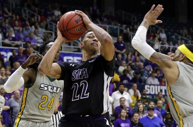 Stephen F. Austin forward TJ Holyfield (22) looks for a way between Southeastern Louisiana guard Keith Charleston (24) and guard Marlain Veal (0) during the second half of an NCAA college basketball game March 10, 2018 in the Southland Conference's Men's Basketball Tournament Championship in Houston. Holyfield, a graduate transfer, is visiting Texas Tech from Saturday through Monday. [AP Photo/Michael Wyke]