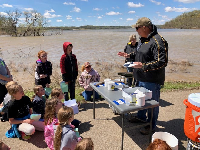 Valley Falls High School environmental sciences teacher Rod Bunde talks to fourth-graders about how to test water clarity at Lake Perry. [Linda Ditch/Special to The Capital-Journal]