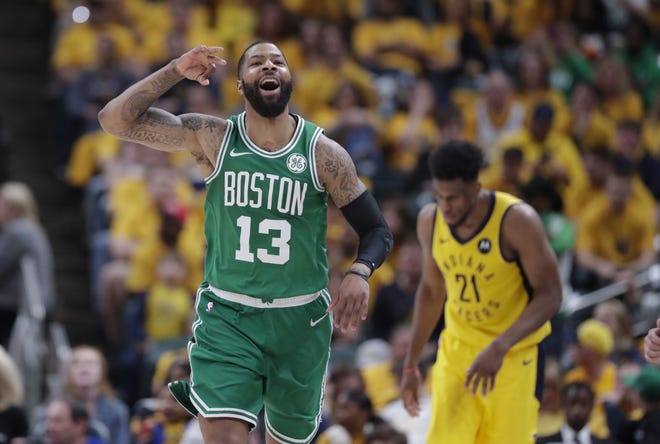 Boston Celtics forward Marcus Morris (13) celebrates against the Indiana Pacers during Game 4 of an NBA first-round playoff series Sunday in Indianapolis. [Michael Conroy/Associated Press]