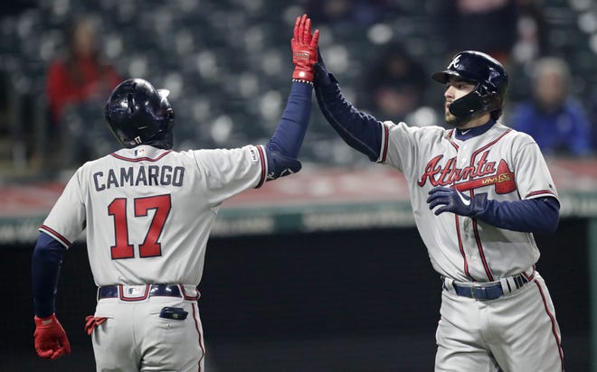 The Atlanta Braves' Dansby Swanson, right, is congratulated by Johan Camargo after Swanson hit a two-run home run off Cleveland Indians relief pitcher Dan Otero in the seventh inning during the second game of a doubleheader Saturday in Cleveland. Camargo scored on the play. [TONY DEJAK/THE ASSOCIATED PRESS]