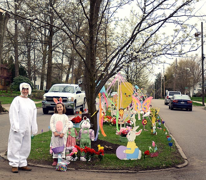 Milton Street residents Beth Simbro and her daughter Kate, 7, greet visitors Sunday during an annual Easter celebration in which neighborhood residents decorate the street's islands and hand out treats to children who visit.