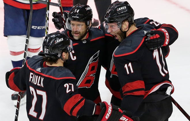 Carolina Hurricanes' Jordan Staal (11), Justin Faulk (27) and Justin Williams (14) celebrate Staal's goal against the Washington Capitals during the third period of Game 6 in the NHL's first-round playoff series in Raleigh, N.C on Monday. [GERRY BROOME / ASSOCIATED PRESS]