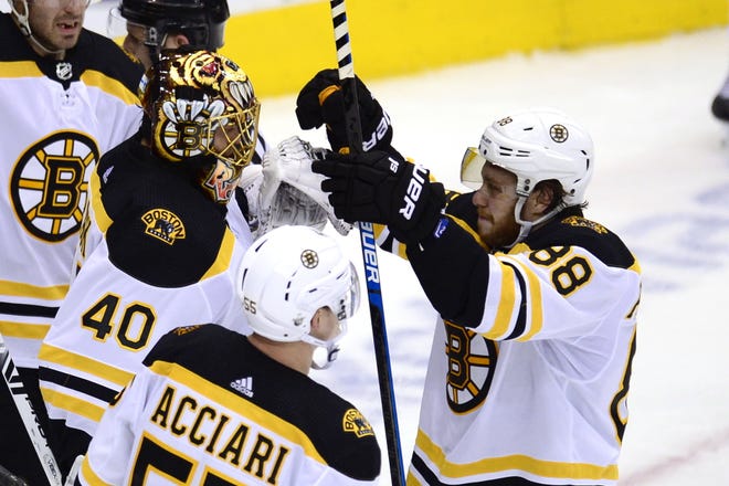 Boston Bruins right wing David Pastrnak (88) celebrates with goaltender Tuukka Rask (40) and center Noel Acciari (55) after defeating the Toronto Maple Leafs in Game 6 of a first-round playoff series, Sunday, in Toronto. The win forced the series to a Game 7 in Boston on Tuesday night. [Frank Gunn/The Canadian Press via AP]