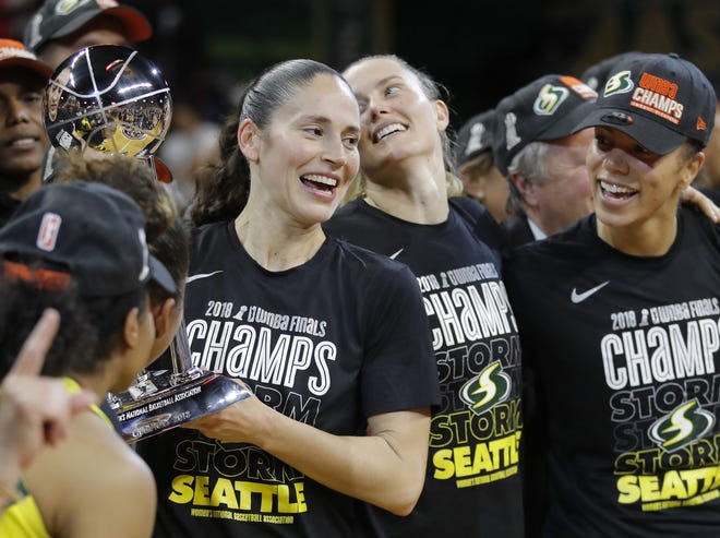 In this Sept. 18 photo, Seattle Storm guard Sue Bird, left, holds the championship trophy with her teammates after winning Game 3 of the WNBA basketball finals in Fairfax, Va. The WNBA is nearly doubling its national TV exposure with a multiyear deal with CBS Sports. [AP Photo/Carolyn Kaster, File]