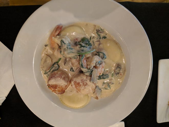 Grilled scallops and shrimp in a goat cheese sauce over homemade ravioli at La Piazza Cafe in Palm Coast [News-Journal/Ashley Varese]
