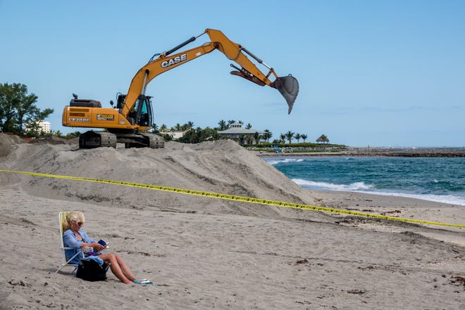 Sand is moved as the Jupiter Inlet District conducts a dredging project from the inlet near DuBois Park to Jupiter Beach Park on Monday in Jupiter. [RICHARD GRAULICH/palmbeachpost.com]
