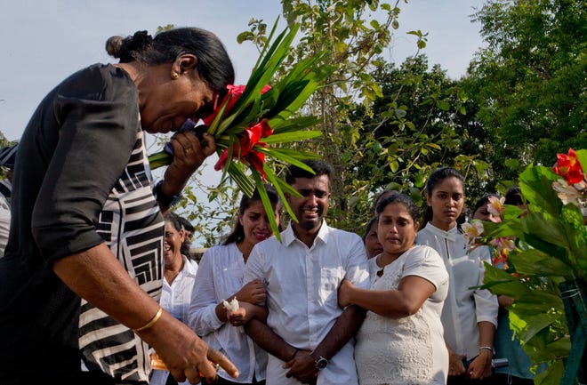 Nilanga Anthony, center, mourns the death of his 7-year-old nephew Dhulodh Anthony, a victim of Easter Sunday bomb blast during the burial at Methodist cemetery Tuesday in Negombo, Sri Lanka. [Gemunu Amarasinghe/The Associated Press]