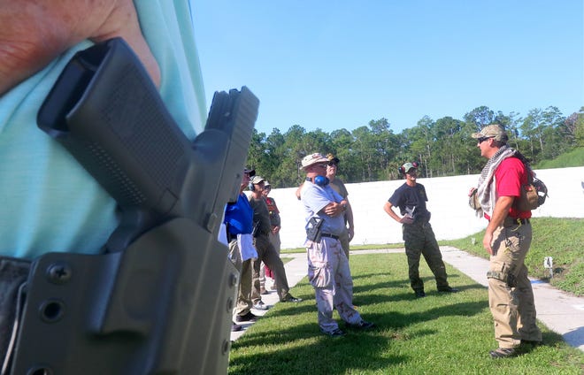 Volusia County Sheriff's Office firearms instructor Randy Post, right, gives school guardians instructions before a live-fire training session in 2018 at the Deputy Stephen Saboda Training Center. The Florida Senate voted Tuesday to expand the guardian program — which was created after the shooting at Marjory Stoneman Douglas High School in Parkland — to allow full-time classroom teachers who volunteer and go through training to carry a gun at school if their district participates in the program. [GateHouse Florida / David Tucker]