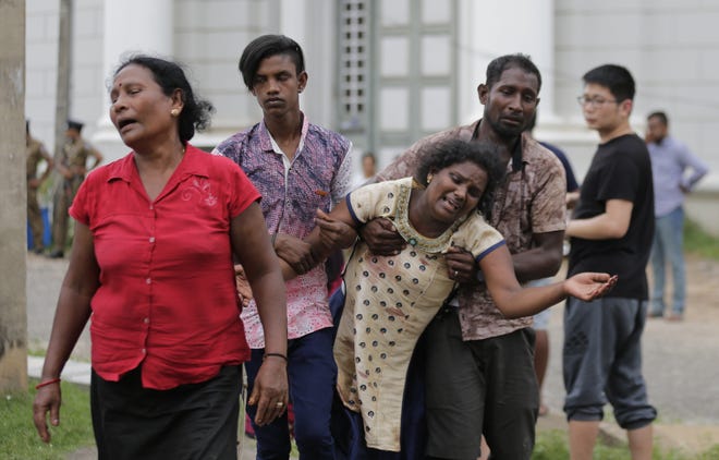 Relatives of a blast victim grieve outside a morgue in Colombo, Sri Lanka, Sunday, April 21, 2019. Hundreds were killed and hundreds more were hospitalized with injuries from eight blasts that rocked churches and hotels in and just outside of Sri Lanka's capital on Easter Sunday, officials said, the worst violence to hit the South Asian country since its civil war ended a decade ago. (AP Photo/Eranga Jayawardena)