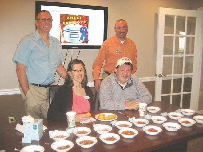 Dave Friedrich, back left, finished first in the chili cook-off at the Coldwell Banker Residential Brokerage office in Greencastle last week, while Andrew Carbaugh's chili placed second among the nine entries judged by Valerie Meyers of the Greencastle-Antrim Chamber of Commerce and Greg Hoover of WRGG. (SHAWN HARDY/ECHO PILOT)