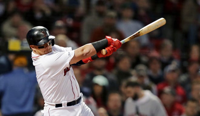 Boston Red Sox's Christian Vazquez follows through on an RBI single during the second inning of a baseball game against the Detroit Tigers at Fenway Park, Wednesday, April 24, 2019, in Boston. (AP Photo/Charles Krupa)