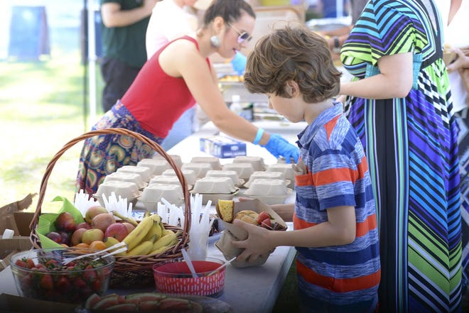 Visitors at the Forsyth Farmers' Market's annual Farm Picnic grab food from a local farm-to-table restaurant, April, 2018. [Will Peebles/savannahnow.com]
