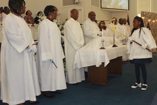 Church elders at PASSAGE Family Church lead Holy Communion during the Resurrection Sunday morning worship service at the church. [PHOTOS BY VOLEER THOMAS/SPECIAL TO THE GUARDIAN]