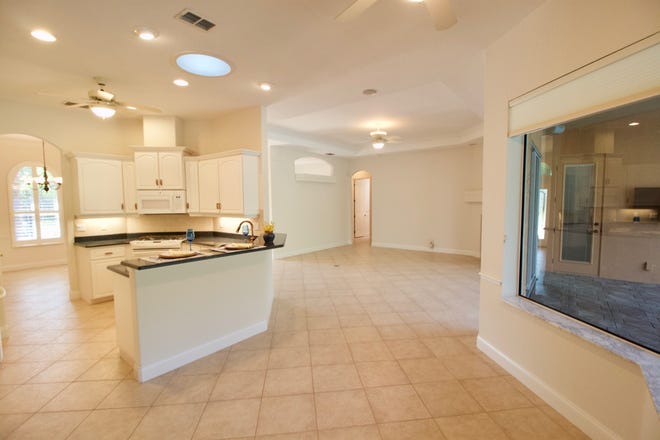 The open-floor plan connects the kitchen with the eat-in area and living room.