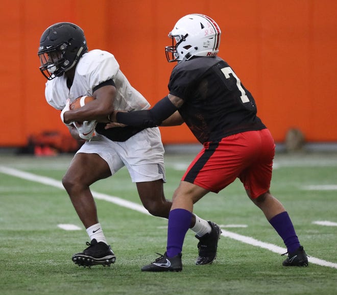 McKinley quarterback Alijah Curtis hands off to Perry running back Jarin Curtis, his cousin, during practice for the Ohio North-South Football Classic on Thursday in Massillon. (IndeOnline.com / Kevin Whitlock)