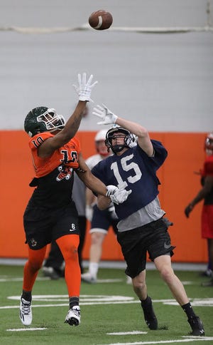 Louisville's Jared Mathie (15) goes to break up a pass intended for Massillon's Kyshad Mack during a drill in practice Thursday for the Ohio North-South Football Classic. (IndeOnline.com / Kevin Whitlock)