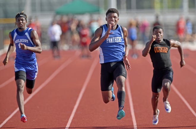 MulberryþÄôs Arian Smith (center) won the boys 100 meter race during the Class 2A, District 9 track meet at Cypress Creek High School in Wesley Chapel, FL on Friday April 12, 2019. Also pictured are MulberryþÄôs Isiah Guinyard (left) and Lake WalesþÄô Roger Williams (right)  [SCOTT WHEELER/THE LEDGER]