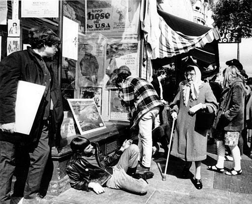 Young hippies straddle the sidewalk as an elderly woman, a long-time resident of the Haight-Ashbury district, walks by in San Francisco, Calif., on April 25, 1967. (AP Photo)