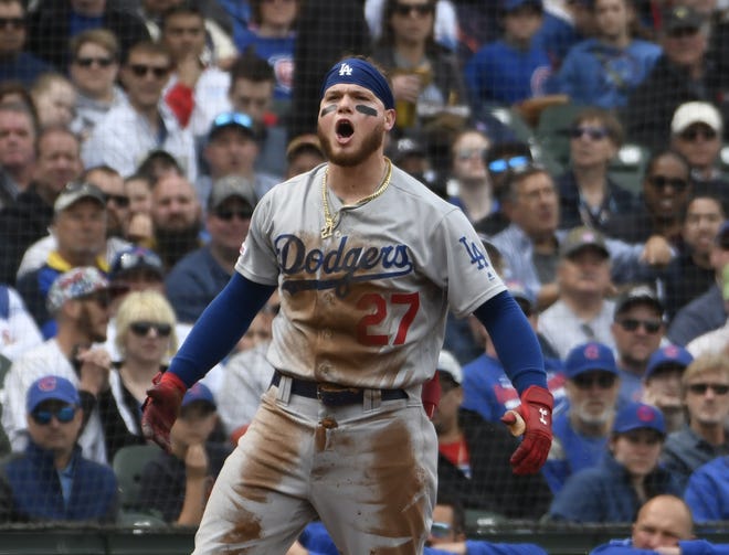 Los Angeles’ Alex Verdugo gestures after hitting a triple in the fifth inning Thursday at Wrigley Field. [David banks/The Associated Press]