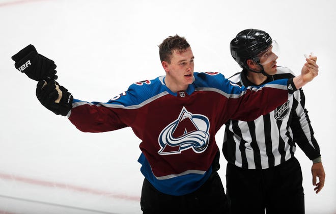 Colorado defenseman Nikita Zadorov exhorts the crowd as he is escorted to the bench after fighting Calgary right wing Garnet Hathaway in the third period of Game 3 on April 15 at the Pepsi Center in Denver. [AP PHOTO/DAVID ZALUBOWSKI]