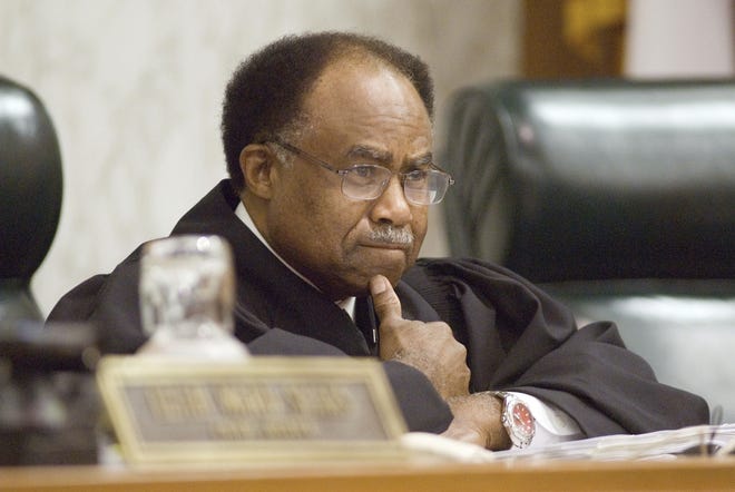 FILE - In a July 16, 2007 file photo, Supreme Court of Georgia Justice Robert Benham presides over a hearing, in Atlanta. Justice who became the first African American to serve on the Georgia Supreme Court, plans to step down in 2020 after serving three decades on the high court., (AP Photo/Zachary D. Porter, Pool, File)