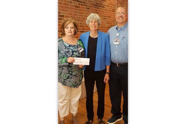 MOST MONEY — Mary Joan Pugh, center, presents Hospice of Randolph County representatives, Lisa Huffman and David Caughron, the award for most money raised by a team. (Contributed)