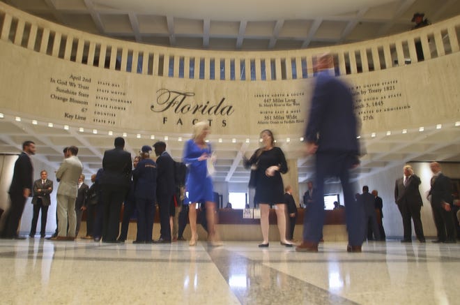 A flurry of activity as legislators, lobbyists and demonstrators pass through the rotunda in the Florida Capitol on Tuesday in Tallahassee. [Phil Sears/The Associated Press]