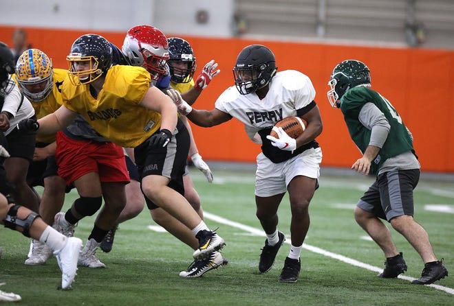 Perry running back Jarin Curtis heads upfield during a North-South practice at Massillon on Thursday. (IndeOnline.com / Kevin Whitlock)