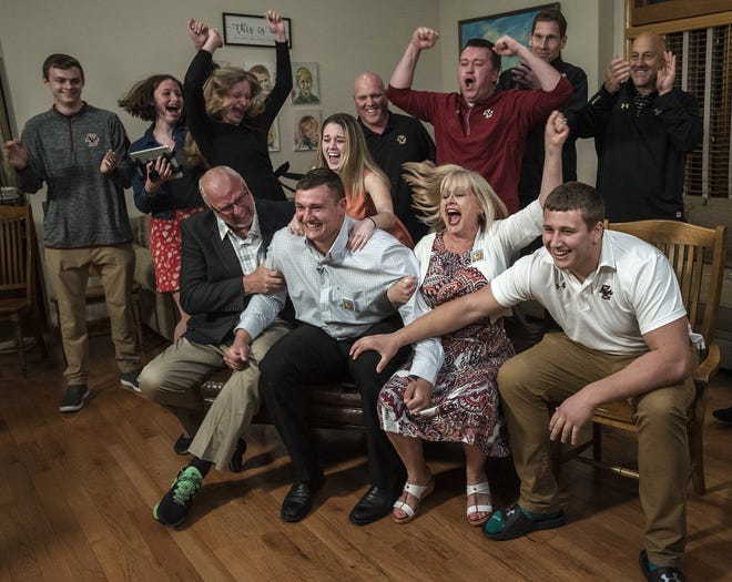 Former Shepherd Hill star Chris Lindstrom, center, and family celebrate Thursday as he is drafted by the Atlanta Falcons as the 14th pick of the first round of the NFL Draft. [T&G Staff/Ashley Green]