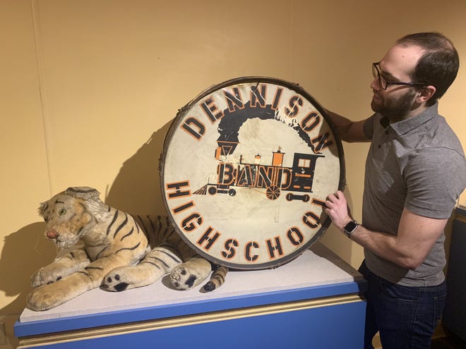 Submitted photo

Jacob Masters sets in place the Dennison High School drum and Uhrichsville High School Tiger mascot.
