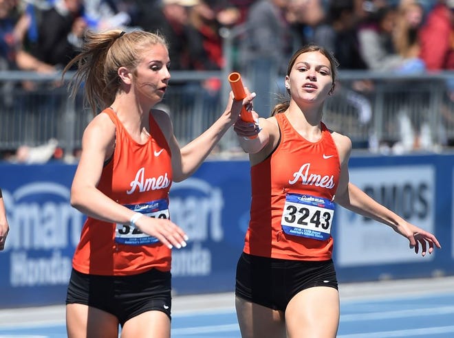 Ames' Hope Morken takes the baton from Bianca Sorrentino during the high school girls 4x200-meter relay at the Drake Relays on Friday at Drake Stadium in Des Moines. Photo by Nirmalendu Majumdar/Ames Tribune