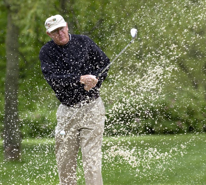 John Havlicek blasts out of a bunker on the first green at the Children's Charity Pro-Am at Willowbend in 2003. [Cape Cod Times File]