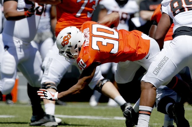 Oklahoma State's Chuba Hubbard (30) dives forward during a scrimmage April 20 in Stillwater. Hubbard is coming off a 145-yard rushing performance in the Liberty Bowl. [Sarah Phipps/The Oklahoman]