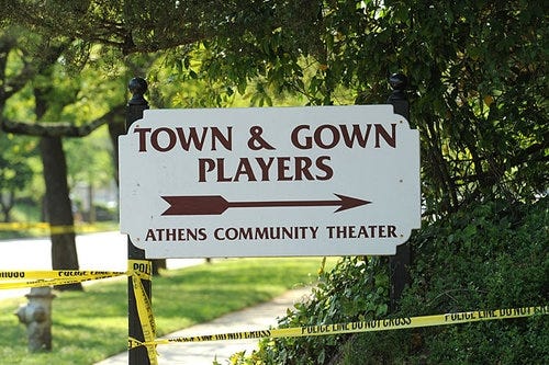 FILE - Crime scene tape surrounds the Athens Community Theater where three people were murdered at a picnic the afternoon of April 25, 2009.